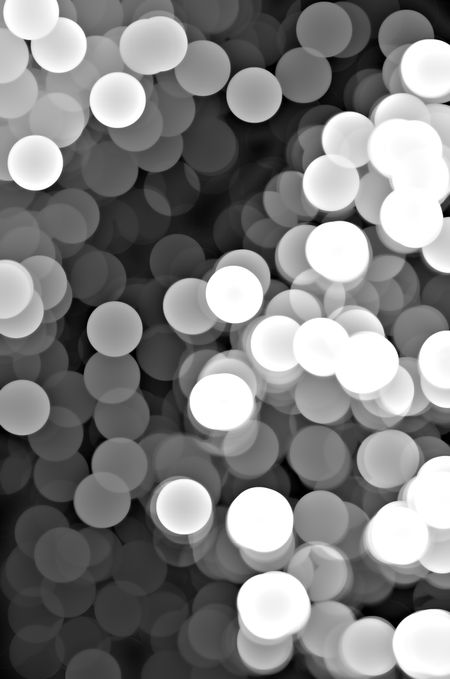 Abstract illustration of many theatrical lights out of focus, in black and white, with illusion of three dimensions, for dramatic or artistic themes in decoration and background