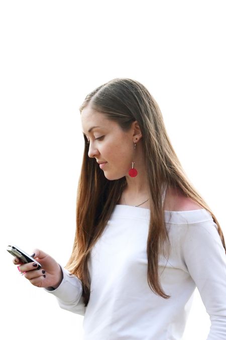 girl sending an sms dressed in white
