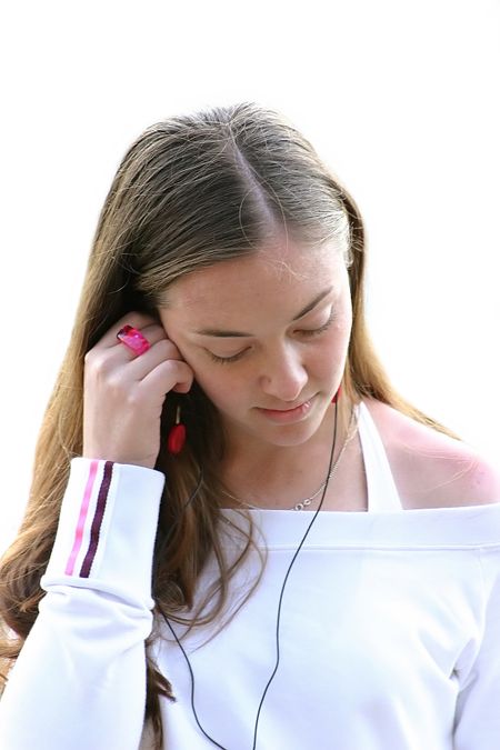 girl in white relaxing by listening to music