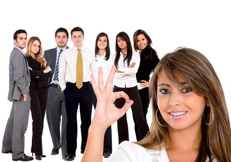 Business woman doing an ok sign and her team isolated