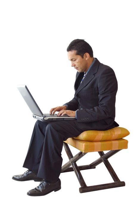 business man using a laptop on a wooden chair