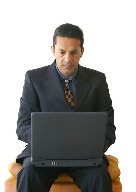 business man working on a laptop sitting on a stool