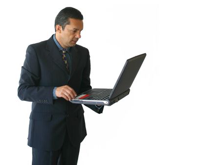 business man standing working on his laptop