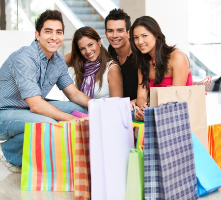 Group of friends with bags at a shopping center