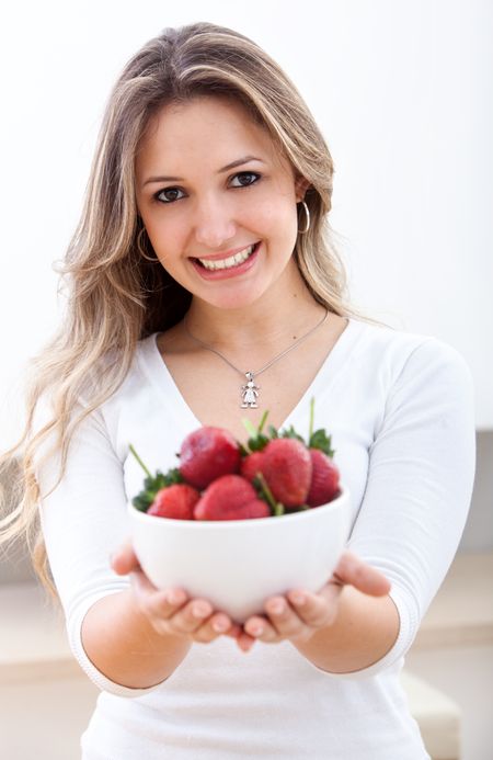 Woman holding some strawberries isolated over white