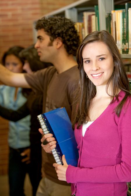 Group of students at a library smiling