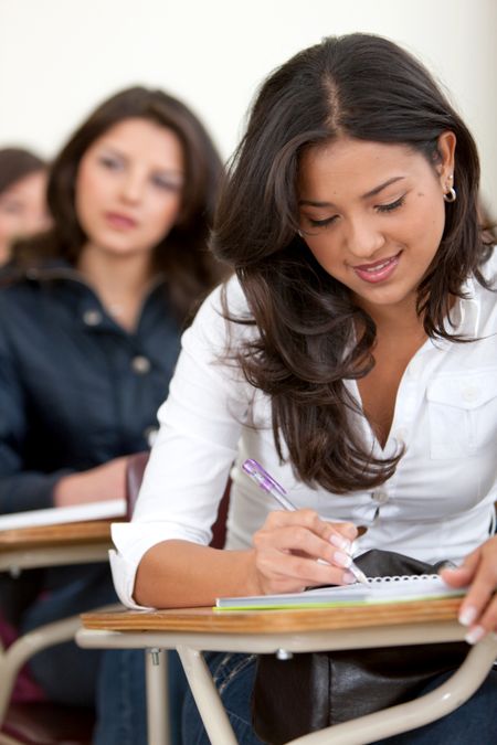 female university student in a classroom smiling