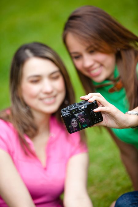 Girls outdoors taking a picture of themselves