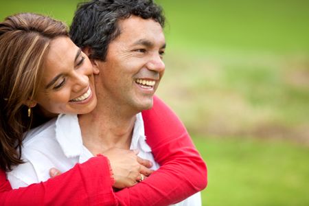 Beautiful romantic couple hugging and smiling outdoors