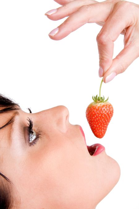 Woman eating a strawberry from above on white background