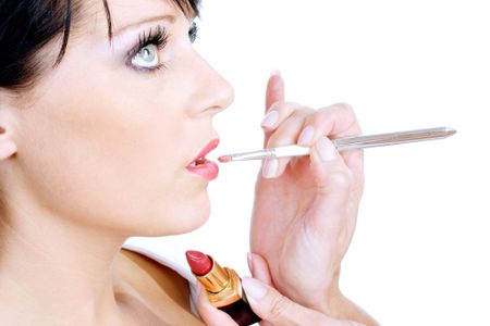 Cosmetics being applied to female model on white background