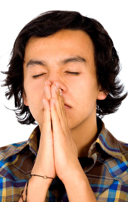 casual man praying with his eyes closed over a white background