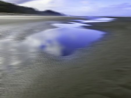 Abstract of large reflective tide pools on a long sandy beach along the Pacific coast of the Olympic Peninsula in Washington state, USA, for marine, environmental, or travel themes