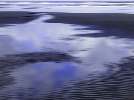 Serene abstract of tide pool draining through channel across sandy beach back toward the ocean along Pacific coast of Olympic Peninsula in Washington, for themes of nature, transience, the environment