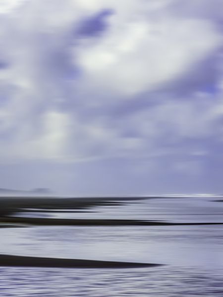 Scenic abstract of morning clouds above long sandbar projections in intertidal zone along Pacific coast of Olympic Peninsula in Washington, USA, for themes of nature, transience, the environment