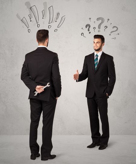 Ruthless businessman handshake with drawn exclamation and question marks around them head