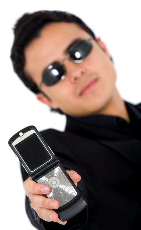 serious incognito man in black showing a phone - isolated over a white background