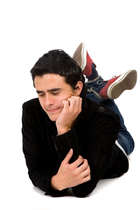 Casual man on the floor looking down at something next to him - good for you to put an element there - isolated over white