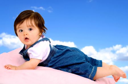baby girl portrait over a blue sky