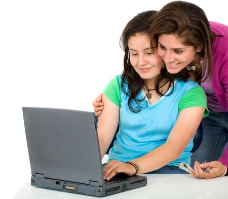 girls working on a laptop computer - isolated over a white background