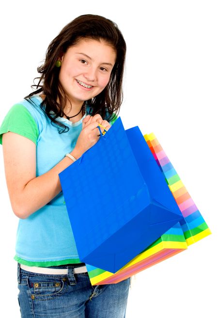 teenage girl with shopping bags - smiling isolated over a white background