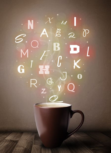 Coffee cup with colorful letters, close up