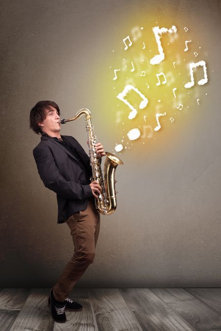 Handsome young musician playing on saxophone with musical notes