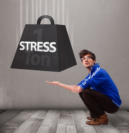 Handsome young boy holding one ton of stress weight