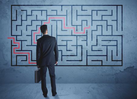 Businessman finding the solution of a maze