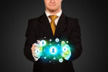 Businessman holding social media network icons structure