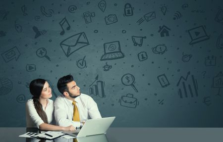 successful-business-couple-kind-media-icons-336365501 Successful business couple with all kind of media icons in background