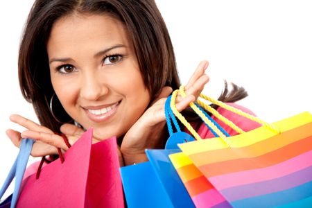 Beautiful shopping girl holding some bags isolated