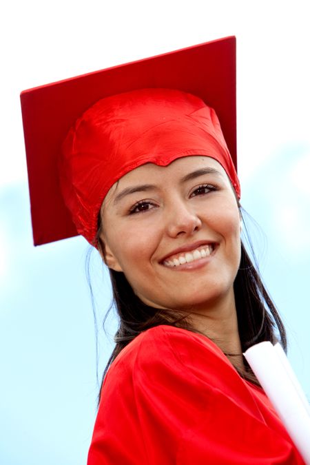 beautiful graduate female smiling in red gown