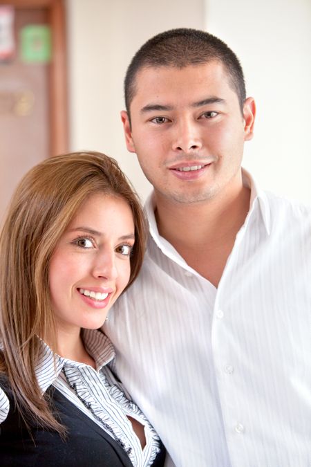 Businesswoman with her partner smiling in an office