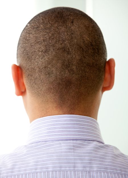 Business man head seen from behind in an office