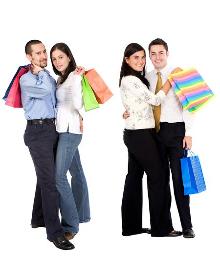 Loving couples with shopping bags isolated over white
