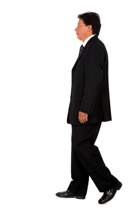 Business man walking from one side of the frame to the other - isolated over a white background