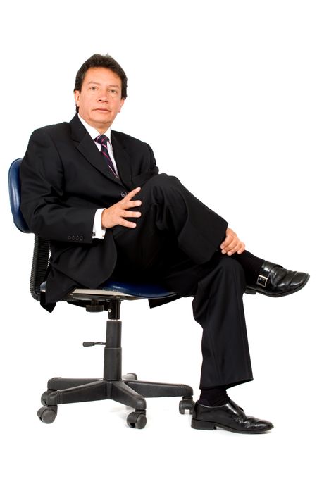 confident business man portrait sitting on a chair - isolated over a white background