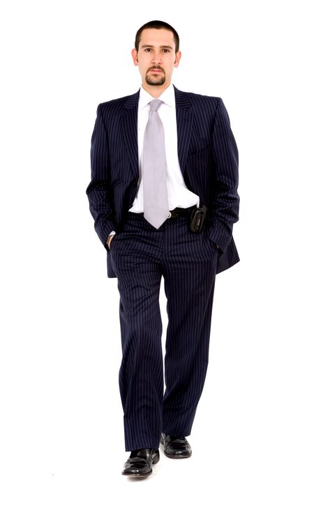 Business man walking towards the camera - isolated over a white background