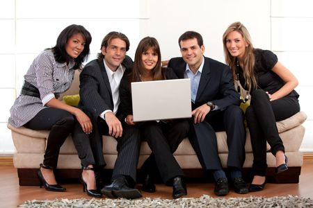 Businessteam sitting on a couch with a laptop