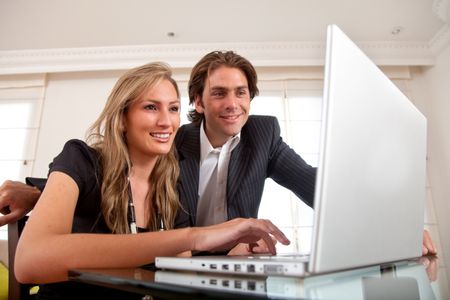 Business couple working on a laptop in an office