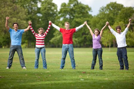 Casual group of excited friends standing outdoors