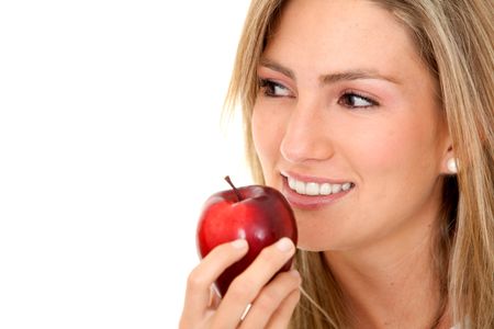 Portrait of a beautiful woman eating an apple isolated