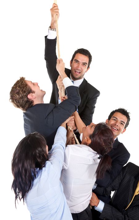 Business team making an effort to climb up a rope isolated