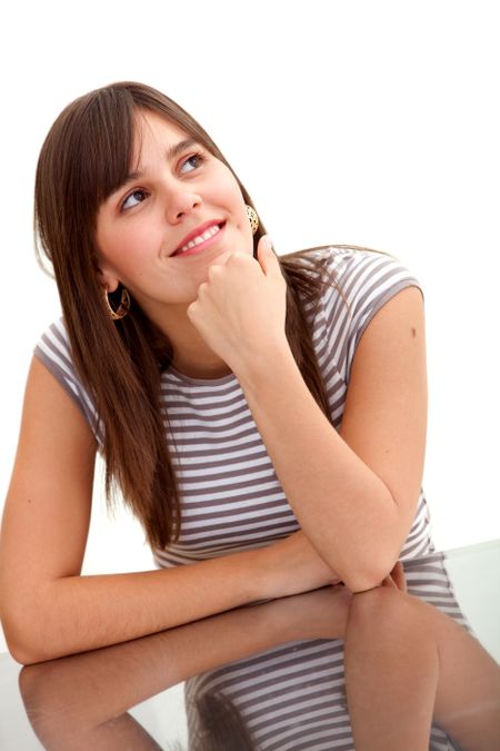 Thoughtful woman leaning on a table isolated