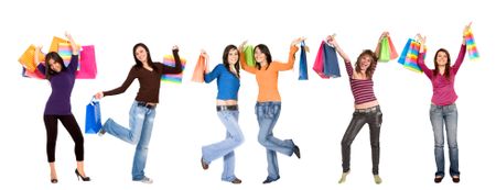 girls smiling and carrying shopping bags isolated