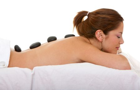 Beautiful woman getting a got stones massage isolated
