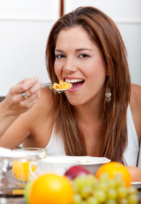 Beautiful woman eating a healthy nutritional breakfast