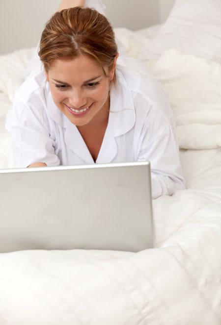 BEautiful woman in bed with a laptop computer