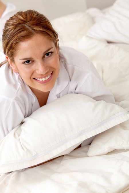 Beautiful woman in bed with a pillow